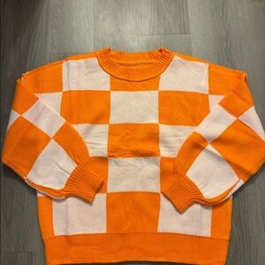 Orange and white sweater.